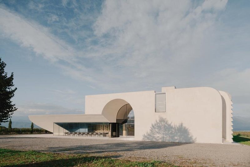 arches and voids carve winery’s monolithic white facade in georgia