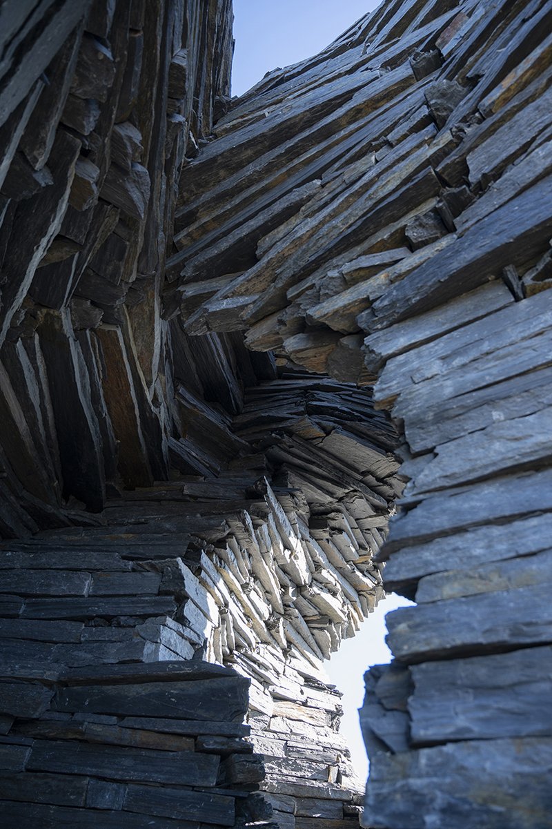 atelier yokyok sculpts sphere land installation out of black schist and granite in portugal