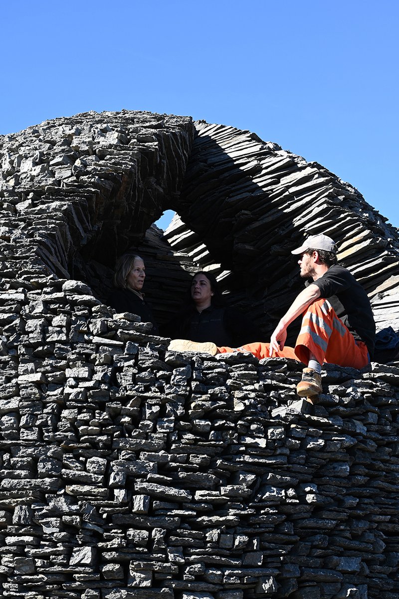 atelier yokyok sculpts sphere land installation out of black schist and granite in portugal